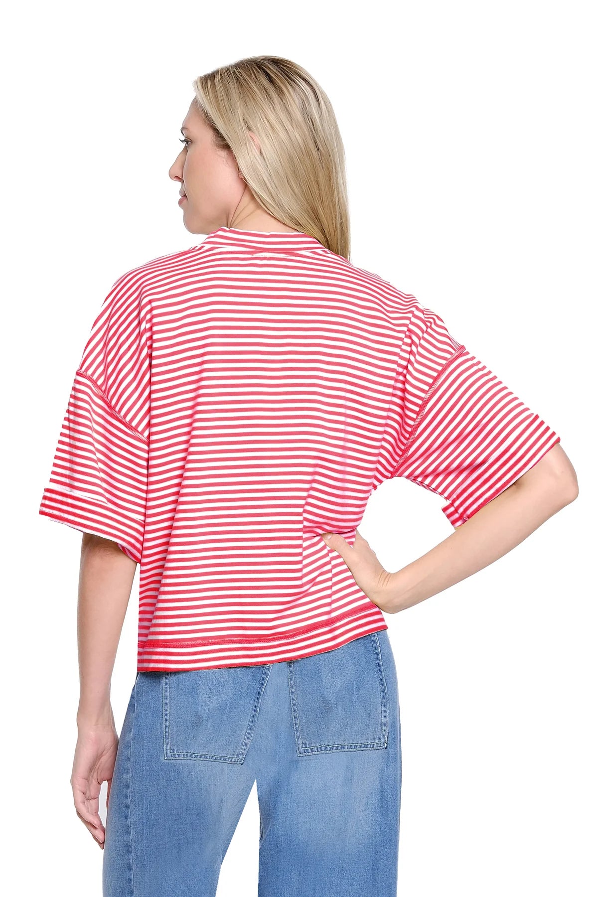 Woman wearing a red and white striped shirt and blue jeans on a white background