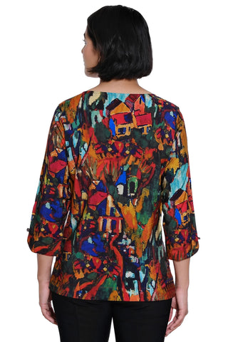 A woman viewed from the back wearing a Ali Miles colorful abstract print top with three-quarter sleeves and black pants, against a plain white background.