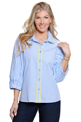 Woman wearing a blue and white striped shirt with yellow accents on a white background