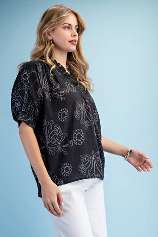 Woman wearing a Gigio boutique brand black floral patterned top 