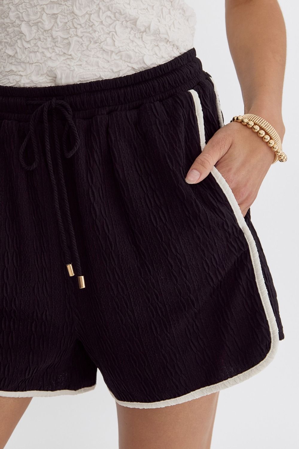 Black shorts with white trim by Entro close up