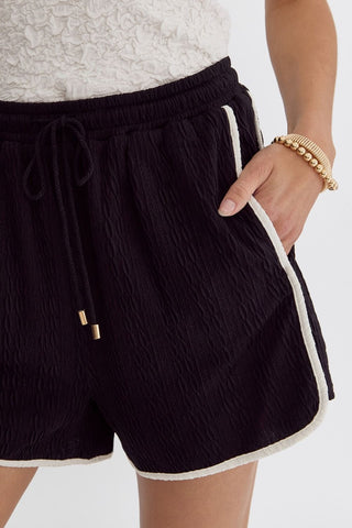 Black shorts with white trim by Entro close up