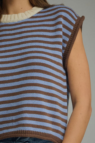 A close-up of a person wearing a Entro sleeveless knit top with horizontal brown and light blue stripes, featuring a cream ribbed crew neck and ribbed trim.