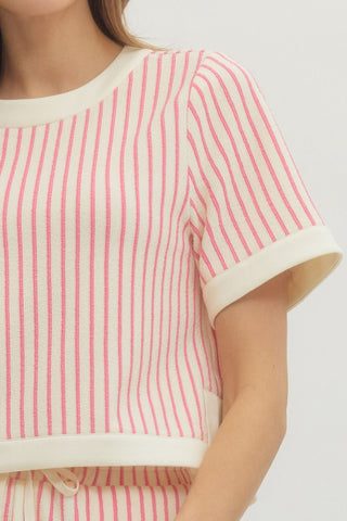 Close-up of a person wearing a light pink and white striped shirt