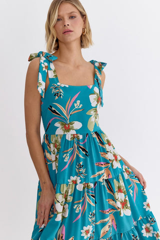 Closeup view of an Entro turquoise blue floral tiered dress with shoulder ties