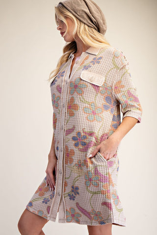 A woman wearing an Easel light beige waffle shirt dress with a colorful floral print. Style #ET72042