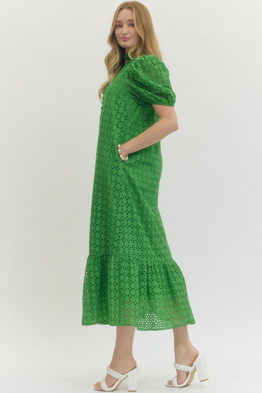 Woman wearing a green dress with a white background