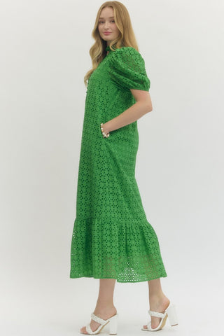 Woman wearing a green dress with a white background