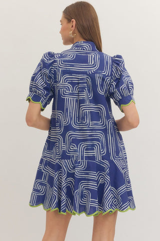 Woman wearing a blue dress with white geometric pattern Entro back view D13609