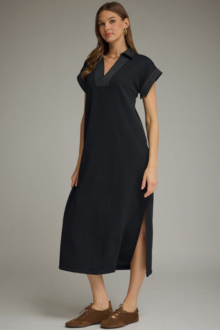 Woman wearing an Entro black midi dress with a side slit