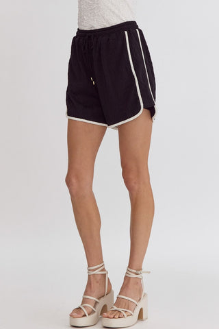 Black textured shorts with white trim by Entro with a tie at waist