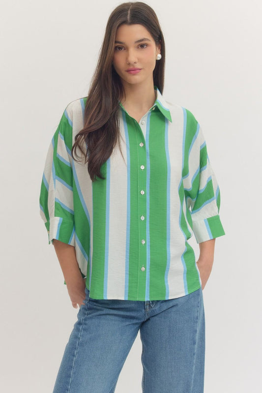 Woman wearing an Entro green blue and white striped shirt with blue jeans style #T30989