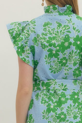 Green floral dress on a plain background