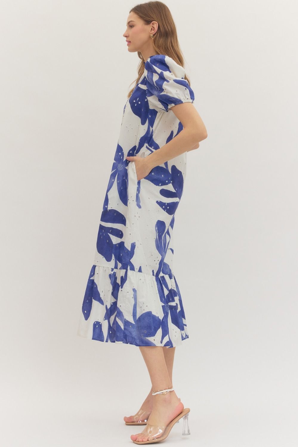 Woman wearing an Entro blue and white floral eyelet midi dress side view