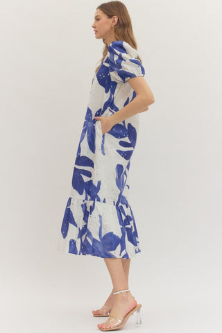 Woman wearing an Entro blue and white floral eyelet midi dress side view