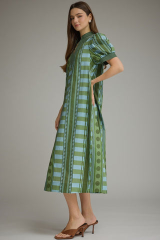 A side view of a woman modeling a short-sleeve midi dress with a green and light blue striped pattern.
