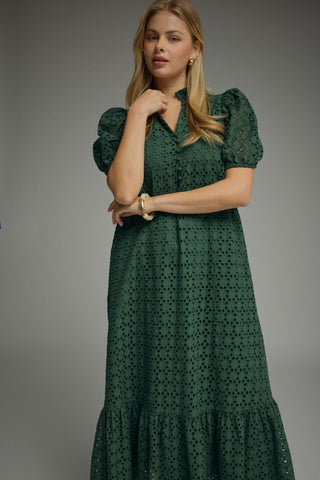 Woman wearing an Entro dark green eyelet lace button front dress with puff sleeves