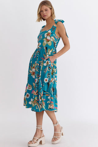 Woman wearing an Entro blue floral print sleeveless dress with a smocked back