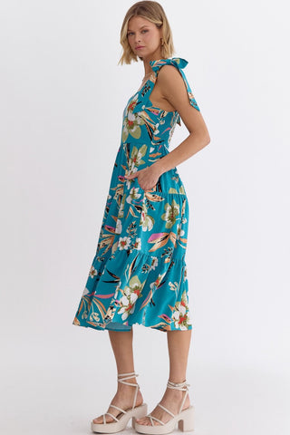 Woman wearing an Entro blue floral print summer dress with shoulder ties