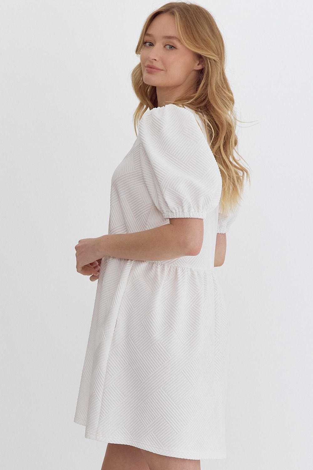 Woman wearing an Entro white square neckline mini dress side view