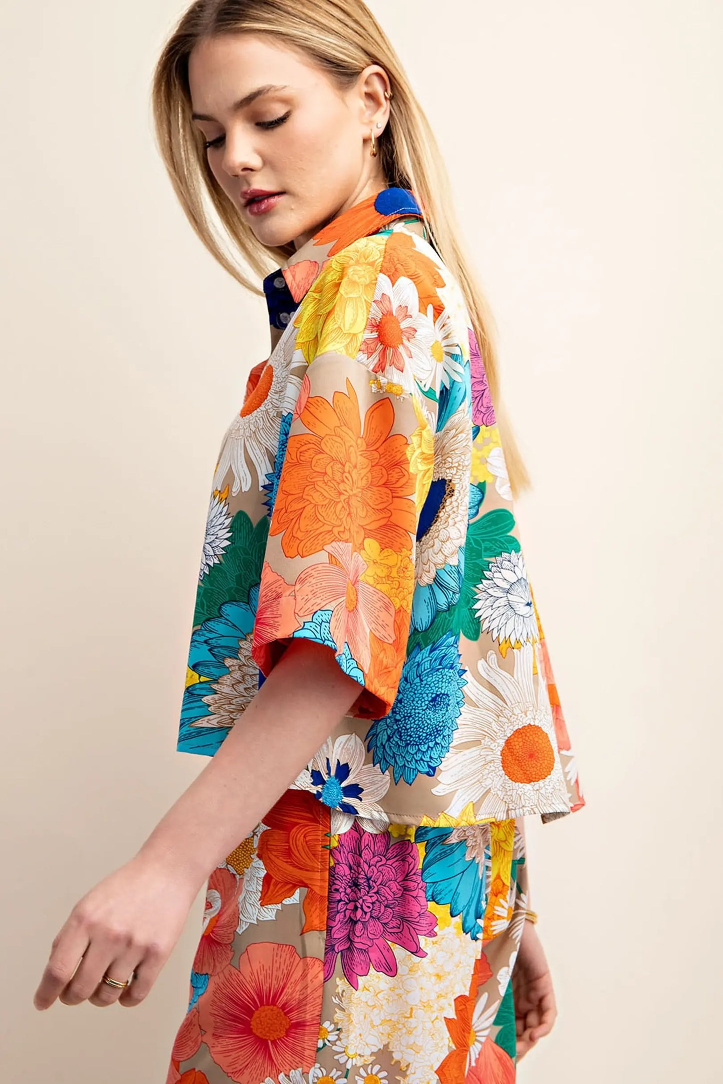 Woman wearing a colorful floral top by boutique brand Gigio