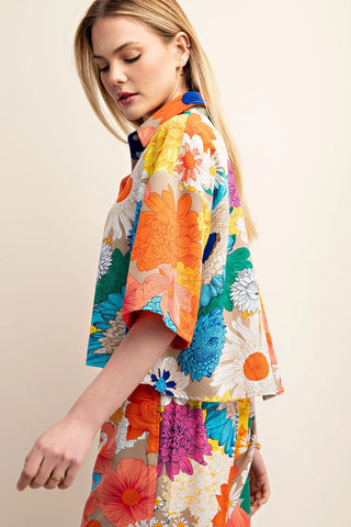 Woman wearing a colorful floral top by boutique brand Gigio