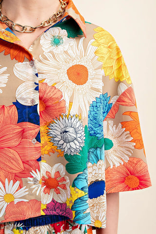 Colorful floral Gigio cropped top closeup with a beige background