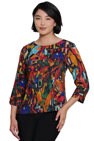 A woman modeling a Ali Miles colorful abstract print blouse with three-quarter sleeves and black pants, photographed against a plain white background.