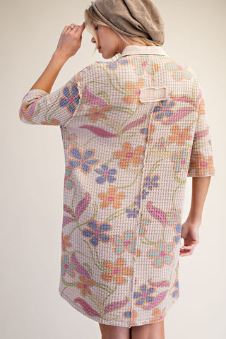 A woman shown from the back wearing an Easel waffle-knit shirt dress with a colorful floral pattern. Style #ET72042