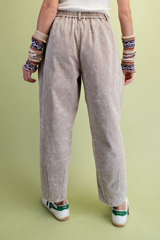 A person shown from the back wearing Easel loose, wide-leg beige pants with a subtle speckled texture.