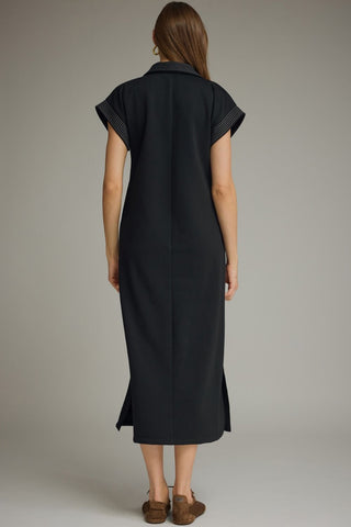 Rear view of an Entro black midi dress with short sleeves and a slit on each side 