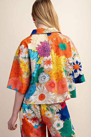 Woman wearing a colorful floral Gigio cropped top rear view