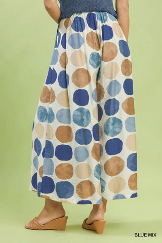 Back view of woman wearing blue and brown polka dot pattern wide leg pants
