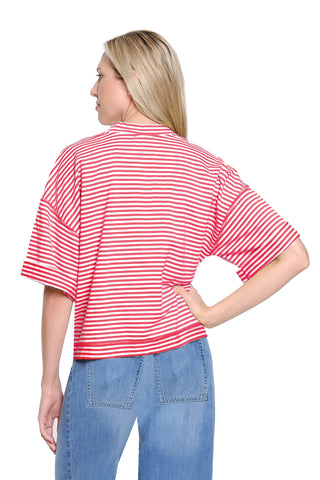 Woman wearing a red and white striped shirt and blue jeans on a white background