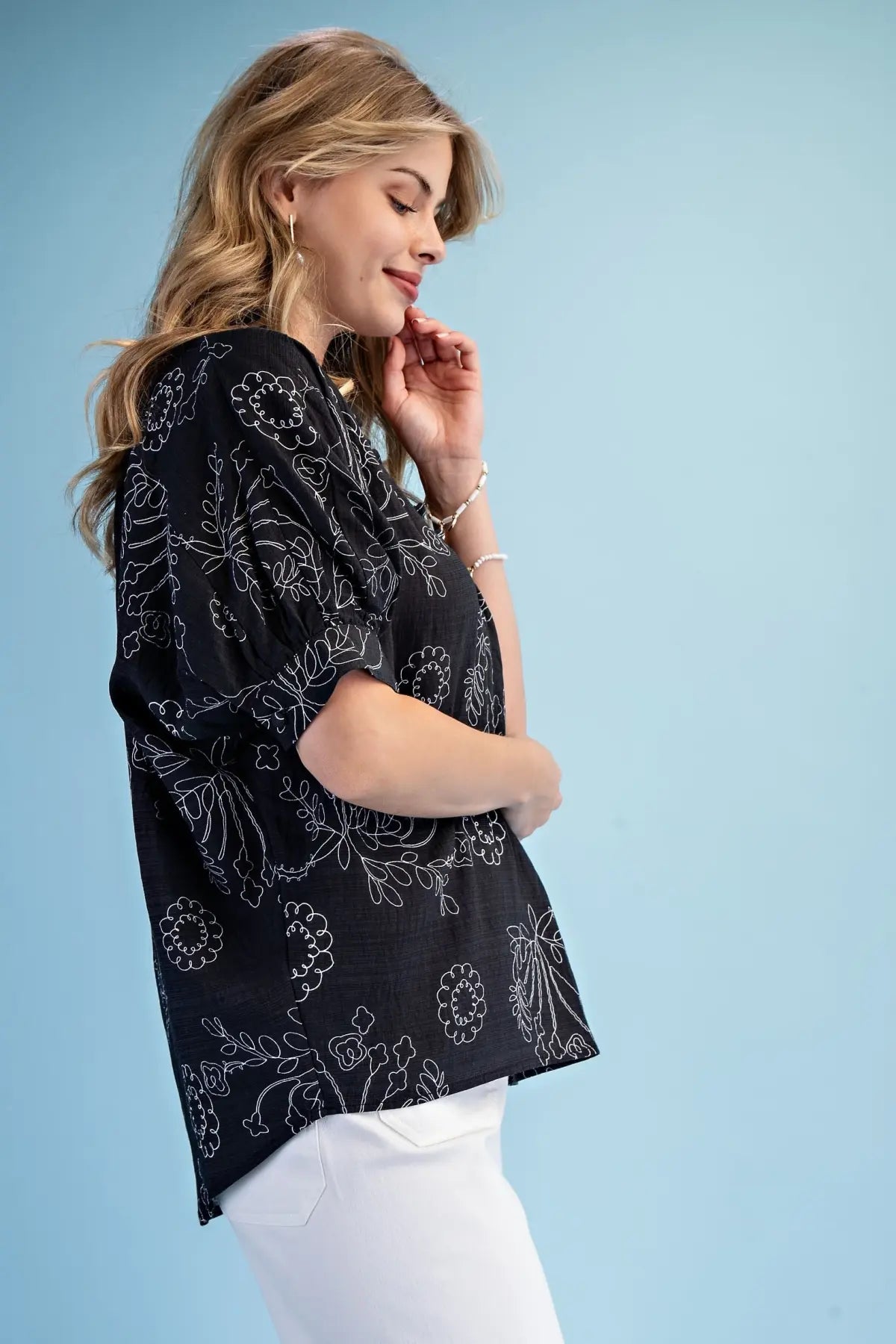 Woman wearing a Gigio black patterned top style #Te1999 