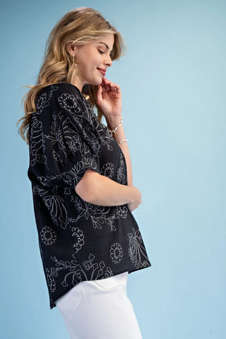 Woman wearing a Gigio black patterned top style #Te1999 
