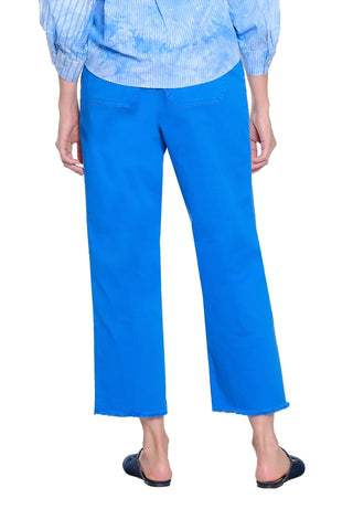 Person wearing blue pants and a light blue checkered shirt on a white background