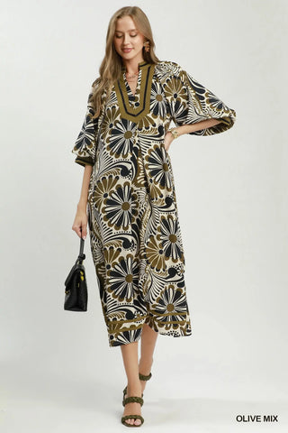 Woman wearing an Umgee
Olive and black patterned dress