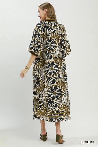 Woman wearing an Umgee olive patterned midi dress. Style #D1137