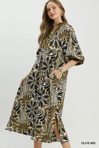 Woman wearing a patterned midi dress with a side slit